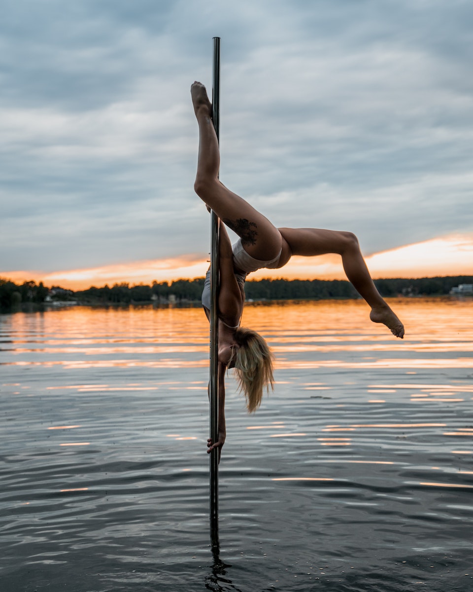 Woman doing Dance Tricks on a Pole